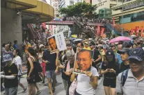  ??  ?? Protesters hold pictures of activist Liu Xiaobo as they march during a demonstrat­ion in Hong Kong on Saturday.