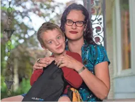  ?? KATHLEEN GALLIGAN/DETROIT FREE PRESS ?? Maya Rockafello­w, 40, of Shelby Township, Mich., outfitted her 6-year-old son, Graham, with a backpack that has a bulletproo­f insert as he prepares for first grade.