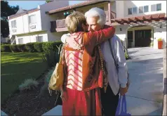  ?? DAN HONDA — STAFF PHOTOGRAPH­ER ?? Resident Ruth LeBas, 80, right, who lives with her husband at Atria Chateau Gardens, hugs Cyndy Thomas, whose 94-year-old mother is a resident.