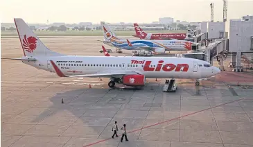  ?? SEKSAN ROJJANAMET­AKUL ?? Thai Lion Air, Nok Air and Thai AirAsia jets at Don Mueang airport.