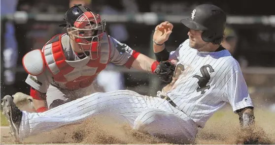  ?? ApphoTo ?? COUNT IT: Kevan Smith slides home ahead of the tag by Red Sox catcher Christian Vazquez during the seventh inning of the White Sox’ win yesterday in Chicago.