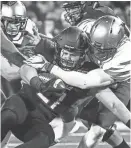  ??  ?? Memphis defender Curtis Akins (right) tackles Tulsa running back Rowdy Simon (left) last season. MARK WEBER/THE COMMERCIAL APPEAL