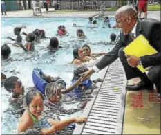  ?? TRENTONIAN FILE PHOTO ?? Trenton Mayor Eric Jackson greeting kids in 2014 at the official opening of the Martin Luther King Jr. swimming pool.