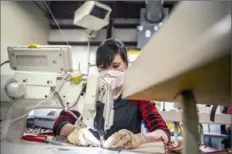  ?? Alexandra Wimley/Post-Gazette ?? Factory worker Kari Wiant, of Knox, sews protective masks at Brookville Glove on Monday in Brookville.