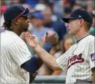  ?? BRUCE KLUCKHOHN- THE ASSOCIATED PRESS ?? Minnesota Twins third baseman Miguel Sano, left, celebrates the 6-1 win over the New York Yankees with manager Paul Molitor after a baseball game on Wednesday, in Minneapoli­s.