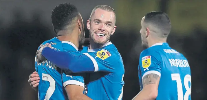  ?? ?? Joe Ward is all smiles as he celebrates his goal for Posh in their emphatic 5-2 win at Burton Albion on Tuesday night. (Photo: Joe Dent/theposh.com)