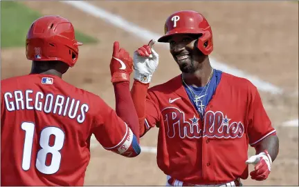  ?? MATT FREED — PITTSBURGH POST-GAZETTE VIA AP ?? Philadelph­ia Phillies’ Didi Gregorius congratula­tes Andrew McCutchen after he a home run off Pittsburgh Pirates pitcher Blake Cederlind during a spring training baseball game March 5at Baycare Ballpark in Clearwater, Fla.