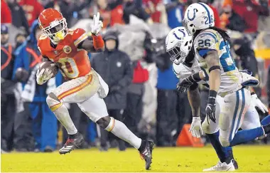  ?? ED ZURGA/ASSOCIATED PRESS ?? Kansas City wide receiver Tyreek Hill (10) gestures as he goes for a big gain during the Chiefs’ victory over visiting Indianapol­is in the divisional round Saturday. Giving chase are the Colts’ Clayton Geathers (26) and Anthony Walker.