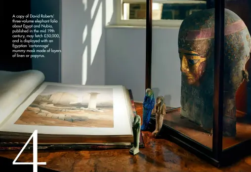  ??  ?? A copy of David Roberts’ three-volume elephant folio about Egypt and Nubia, published in the mid 19th century, may fetch £50,000, and is displayed with an Egyptian ‘cartonnage’ mummy mask made of layers of linen or papyrus.