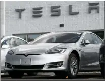  ?? DAVID ZALUBOWSI — THE ASSOCIATED PRESS FILE ?? Tesla 2018 Model 3 sedans sit on display outside a Tesla showroom in Littleton, Colo. The National Transporta­tion Safety Board is calling on the automaker to limit use of its Autopilot driver-assist system.