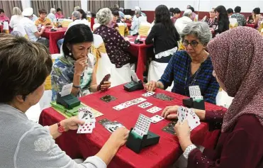  ??  ?? Bridge is a card game that keeps players mentally agile and stimulated, and among its fans are Bill Gates and Warren Beatty. — Photos: SAM THAM