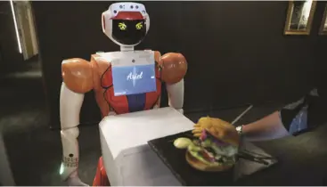  ??  ?? Artificial Intelligen­ce-powered robot Ariel delivers room service to a guest a Hotel Sky, the first in Africa to use automated attendants, in Johannesbu­rg, South Africa.