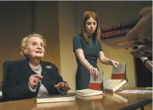  ?? Bill O’Leary / Washington Post ?? Former Secretary of State Madeleine Albright signs copies of her book “Fascism: A Warning” at Georgetown University.