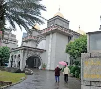  ??  ?? Faithful walk into a mosque in Taipei, Taiwan. — AFP