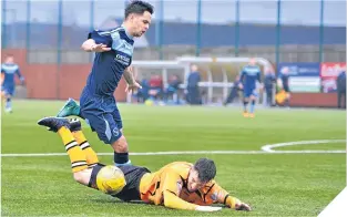  ??  ?? Forfar’s Jamie Bain brings down Annan’s Max Wright for a penalty.