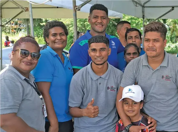  ?? Photo: Waisea Nasokia ?? Swire Shipping Fijian Drua squad member Emosi Tuqiri (back third from left), with fans in Ba. Tuqiri was first drafted into the Vodafone Fijian Under-20 squad by then coach Koli Sewabu in 2018.