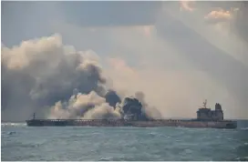  ?? (Reuters) ?? SMOKE BILLOWS from the Panama-registered tanker carrying Iranian oil in this Chinese Ministry of Transport photo from Tuesday.