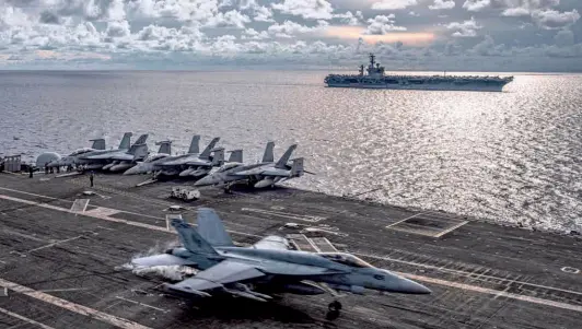  ?? NYT ?? AN F/A-18E SUPER HORNET lands on the flight deck of the USS Ronald Reagan in the South China Sea on July 6. Photograph provided by the U.S. Navy. The U.S. has been ratcheting up its naval presence in the Pacific.