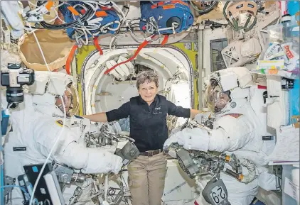  ?? NASA VIA AP ?? Astronaut Peggy Whitson floats inside the Quest airlock of the Internatio­nal Space Station with Thomas Pesquet (left) and Shane Kimbrough before their spacewalk on Jan. 13. Early Monday Whitson, the Internatio­nal Space Station commander, surpassed the...