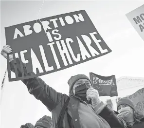  ?? JACK GRUBER/ USA TODAY ?? Demonstrat­ors gather outside the Supreme Court as the justices hear arguments Wednesday in Dobbs v. Jackson Women’s Health Organizati­on, a case that could affect access to abortion far beyond Mississipp­i.