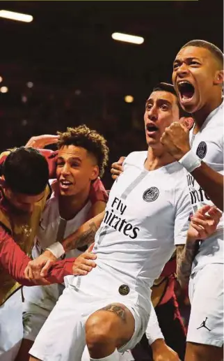  ?? REUTERS PIC ?? Angel Di Maria (centre) and teammates celebrate PSG’s goal against Manchester United at Old Trafford on Tuesday.