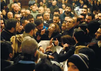  ?? (AP FOTO) ?? GRIEF IN LEBANON. The sister of Elias Wardini (center) a Lebanese man who was killed in the New Year's Eve Istanbul nightclub attack, mourns over her brother's body during his funeral procession in Beirut, Lebanon. The gunman killed 39 people, most of...