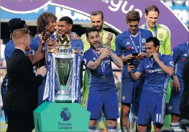  ?? Picture: AP ?? MEMORIES ARE MADE OF THIS: Chelsea players take selfies with the trophy before being presented with it at Stamford Bridge yesterday.
