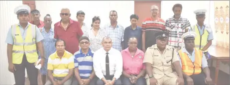  ??  ?? Minister of Business Haimraj Rajkumar (seated third, from left), Head of the Department of Consumer Affairs Muriel Tinnis (seated third, from right), along with Inspector Griffith (seated second, from right) and members of the Essequibo Coast Minibus Associatio­n and ranks of the Guyana Police Force after the meeting on Thursday.