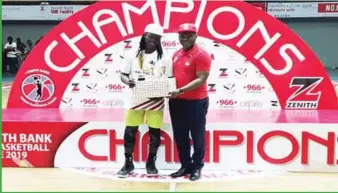  ??  ?? Murjanatu Musa of Air Warriors of Abuja receiving the Most Valuable Player Award from the Executive Director of Zenith Bank, Mr Henry Oroh...on Thursday in Lagos.