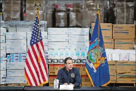  ?? JOHN MINCHILLO/AP PHOTO ?? In this March 24, 2020, file photo, Gov. Andrew Cuomo speaks during a news conference against a backdrop of medical supplies at the Jacob Javits Center that was to house a temporary hospital in response to the COVID-19 outbreak in New York.