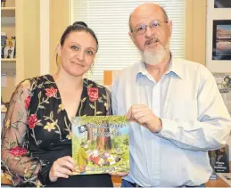  ?? KIRK STARRATT ?? Children’s author Sherri Boudreau (S.L. Boudreau) and Carmen Legge of the History Channel’s hit show The Curse of Oak Island with a copy of Boudreau’s book The Oak Island Treasure Kids. It has reached No. 2 on Amazon’s list of best-selling children’s books about discovery and exploratio­n.