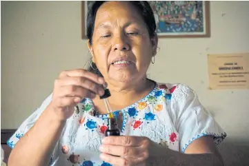  ??  ?? RESTORING THE NATION’S HEALTH: Maria de Jesus Patricio Martinez, an indigenous healer from the Nahuatl ethnic group, talks about the medicines she is preparing during an interview at her clinic in Tuxpan, Jalisco State, western Mexico.