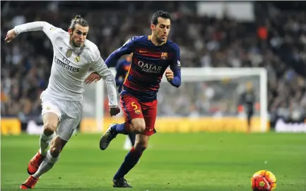  ??  ?? Gareth Bale and Sergio Busquets could go head-to-head in the Clasico on Saturday. (Shuttersto­ck)