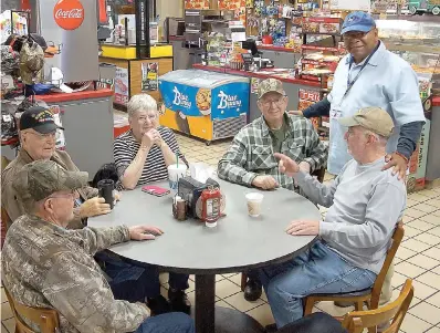  ??  ?? above
■ Seated around a round table near the front door of the Linden Fuel Center are, from left, Jerry Berry, Al and Betty DeLoach, Dennis Spears, bus driver Larry Sasser and Jerry Harp.