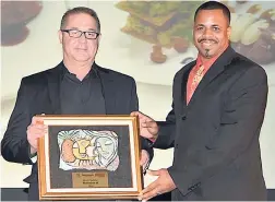  ??  ?? General manager of Hedonism II, Kevin Levee (left), and Anthony Miller, executive chef, pose with their ‘Best in Cuisine’ award during the Hospitalit­y Jamaica Awards.