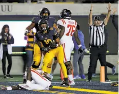  ?? Santiago Mejia / The Chronicle ?? Cal linebacker Cameron Goode (19) celebrates the intercepti­on he ran back for the game-clinching touchdown against Ole Miss.