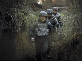  ?? Ukrainian Presidenti­al Press Office ?? UKRAINE is worried that Russia is gearing up its forces to invade. President Volodymyr Zelensky, in front, visits his nation’s war-torn Donetsk region.