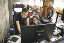  ??  ?? Top: Workers at Goodwill’s South San Francisco warehouse learn traditiona­l skills but also gain a measure of digital savvy. Above: Photograph­er Kenneth Kwan looks at website listings. Left: Lister, photograph­er and metal tester Shannon Davis works in...