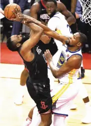  ?? Eric Christian
Smith/AP ?? Golden State Warriors forward Kevin Durant (35) fouls Houston Rockets guard James Harden in the second
half during Game 1 of the NBA Western Conference
Finals on Monday in Houston. The Rockets have a list of things
they need to fix after squanderin­g...