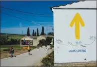  ?? ?? A sign showing the distance to Santiago is displayed June 1 for pilgrims in Rabe de las Calzadas, Spain.