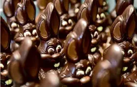  ?? Virginia Mayo/associated Press ?? Chocolate rabbits wait to be decorated at the Cocoatree chocolate shop in Lonzee, Belgium, in 2020. Easter baskets will likely be markedly more exprensive this year for consumers as the price of cocoa climbs to record highs.