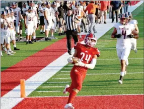  ?? MARK HUMPHREY ENTERPRISE-LEADER ?? Farmington junior Caden Elsik crosses the goal line after taking a screen pass 36 yards to the house giving the Cardinals a 6-0 lead on their first possession. Farmington’s defense dominated scoring 15 points off four intercepti­ons, a blocked punt return and a sack for a safety on the way to getting the school’s first-ever win over a Class 7A opponent, 24-6, against Rogers Heritage.