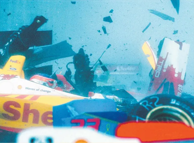  ?? Main picture: WAYNE JONES ?? Racing driver Jimmy Vasser in the midst of a nine-car pileup at the Indy 300 race in 2002; and 1991 winner John Andretti with the trophy.