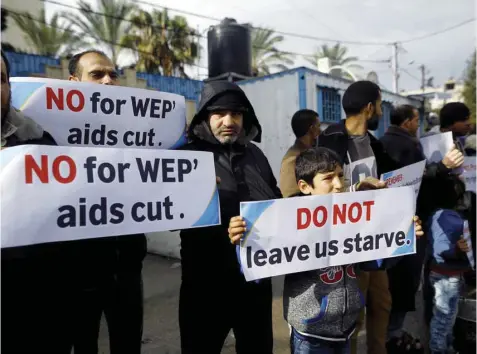  ?? — AFP ?? Palestinia­ns take part in a protest against aid cuts outside of United Nations’ offices in Gaza City on Wednesday.