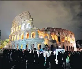  ?? Vincenzo Pinto AFP/Getty Images ?? A CROWD gathers at the Colosseum in Rome before it turned off its lights Saturday. The Eiffel Tower and Big Ben were among other sites to mark Earth Hour.