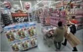  ?? JULIO CORTEZ — THE ASSOCIATED PRESS FILE ?? In this Wednesday file photo, a shopper, left, walks with a store associate in the toy section at Walmart in Teterboro, N.J.