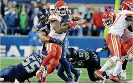  ?? [AP PHOTO] ?? Former Oklahoma running back Damien Williams of Kansas City is tackled by Seattle linebacker Bobby Wagner in Sunday’s loss to the Seahawks. The Chiefs need to beat Oakland on Sunday to clinch the division title and claim the No. 1 seed in the AFC playoffs.