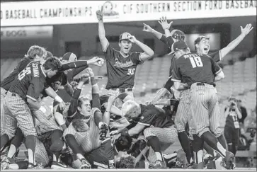  ?? Nick Agro For The Times ?? CYPRESS PLAYERS form the traditiona­l dogpile after defeating Harvard-Westlake at Dodger Stadium.