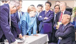  ??  ?? SO WHAT? German Chancellor Angela Merkel shared a picture on her official Instagram account that shows her staring down President Donald Trump during the G-7 Summit in Canada. Japanese Prime Minister Shinzo Abe is also in the photograph, standing with his arms crossed; France’s Emmanuel Macron, on Merkel’s left, seems to be making a point, too. But US president Trump is not listening.