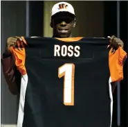  ?? ASSOCIATED PRESS FILE PHOTO ?? Receiver John Ross poses after being selected ninth overall by the Cincinnati Bengals in the 2017 NFL Draft after running an NFL Combine-record 4.22-second, 40-yard dash. He played in only 37games over the next five years, averaging 1.7 catches and 26 yards receiving per game.